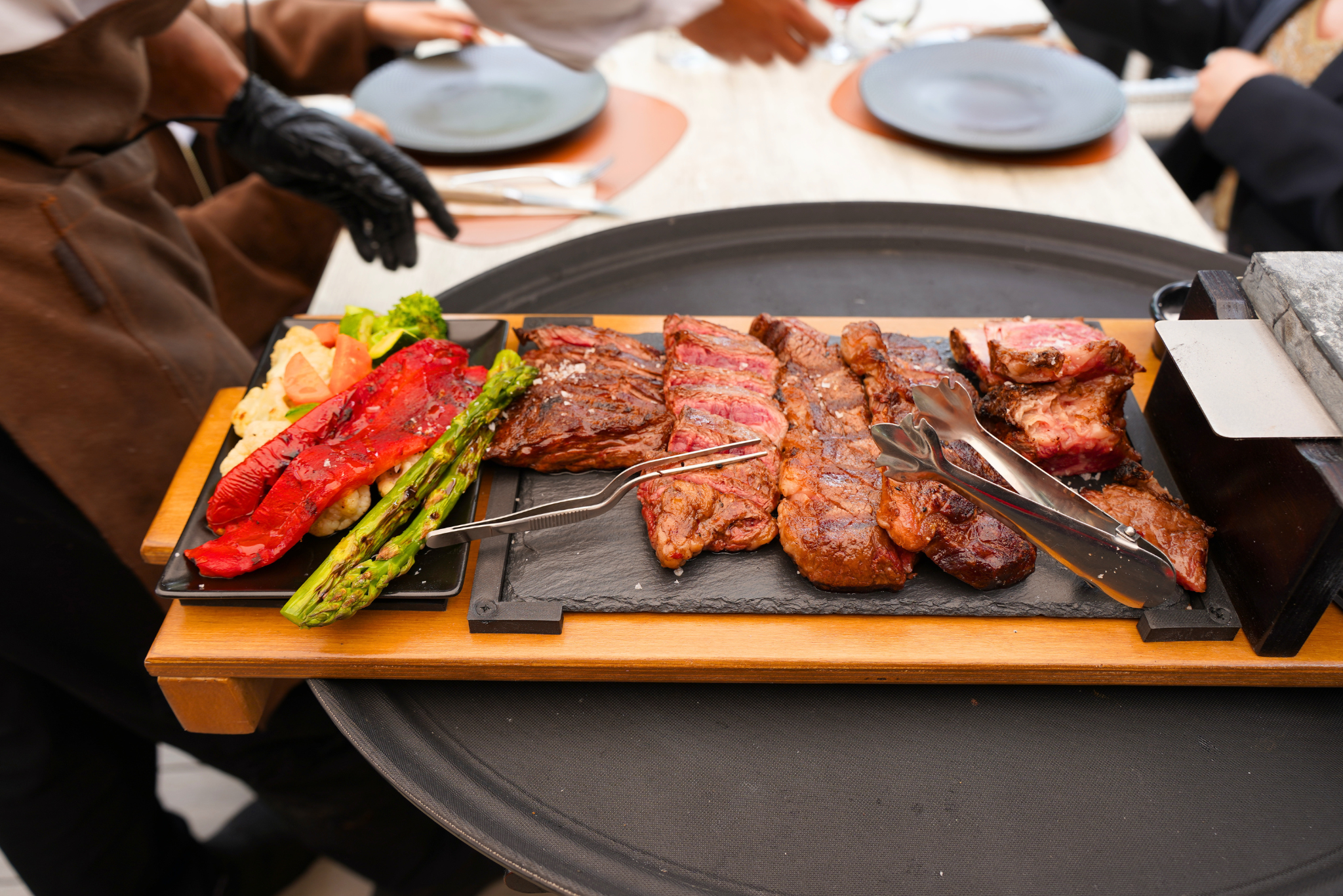 Freshly sliced dry-aged Angus skirt steak served on a slate board